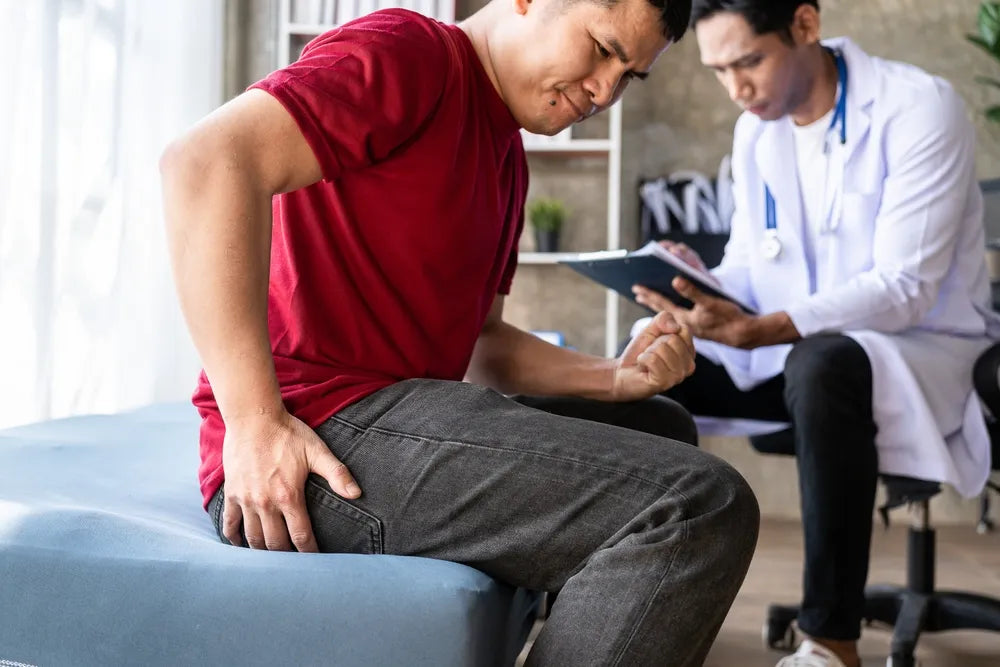 Patient consulting a medical professional about hemorrhoid symptoms