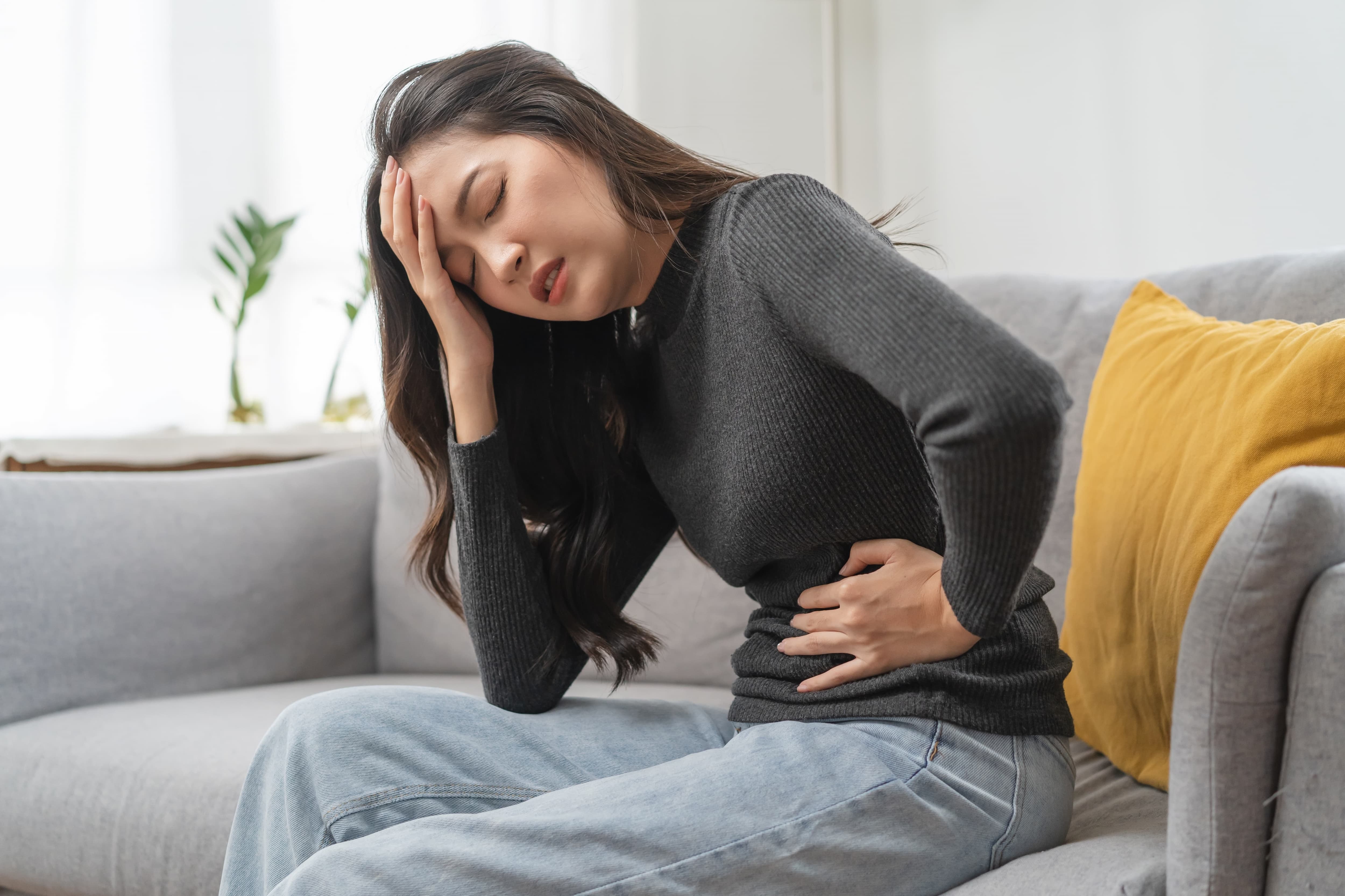 Person experiencing lower abdominal discomfort representing hemorrhoid pain relief options